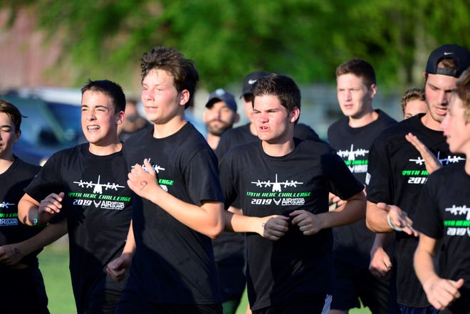 Members of the Clear Fork boys soccer team jog towards the finish line Wednesday to complete the Herc Challenge, which is a conditioning exercise organized and hosted by the Ohio Air National Guard.
