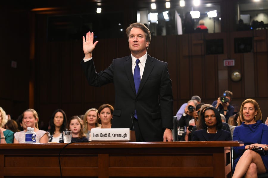 Supreme Court nominee Brett Kavanaugh, with his wife and daughters behind him, was sworn in by the Senate Judiciary Committee during last year's confirmation hearing. Kavanaugh was confirmed, 50-48, after surviving allegations of sexual misconduct as a teen-ager.