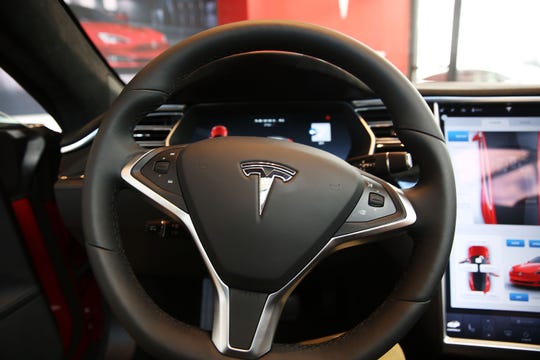 The inside of a Tesla vehicle is viewed as it sits parked in a Tesla showroom and service center in Red Hook, Brooklyn, on July 5, 2016.