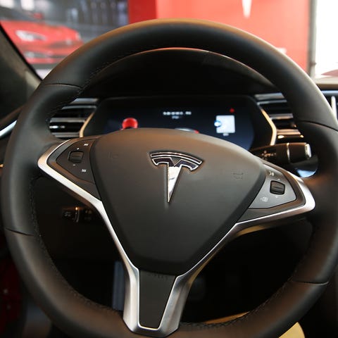 The inside of a Tesla vehicle is viewed as it sits