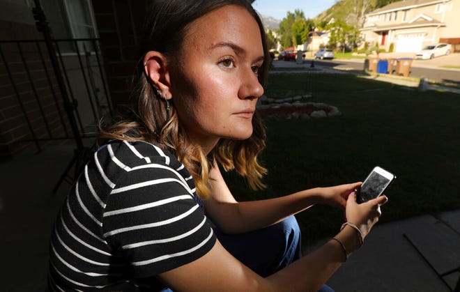 In this Monday, July 22, 2019, photo, Rachel Whalen poses at her home in Draper, Utah. Whalen remembers feeling gutted in high school when a former friend would mock her online postings, threaten to unfollow or unfriend her on social media and post inside jokes about her to others online. The cyberbullying was so distressing that Whalen even contemplated suicide. There's a rise in cyberbullying nationwide, with three times as many girls reporting being harassed online or by text message than boys, according to the National Center for Education Statistics. (AP Photo/Rick Bowmer)