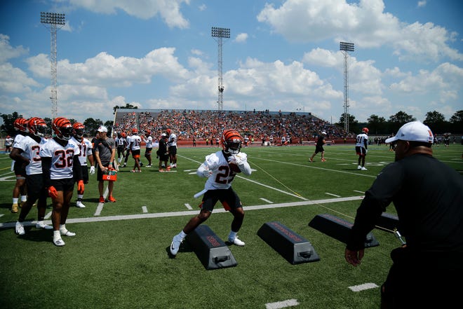 Cincinnati Bengals running back Giovani Bernard (25) runs through a ball security drill during the opening day of training camp at Welcome Stadium in Dayton, Ohio, on Saturday, July 27, 2019.