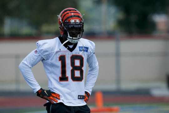 Cincinnati Bengals wide receiver A.J. Green (18) rests between reps during the opening day of training camp at Welcome Stadium in Dayton, Ohio, on Saturday, July 27, 2019.