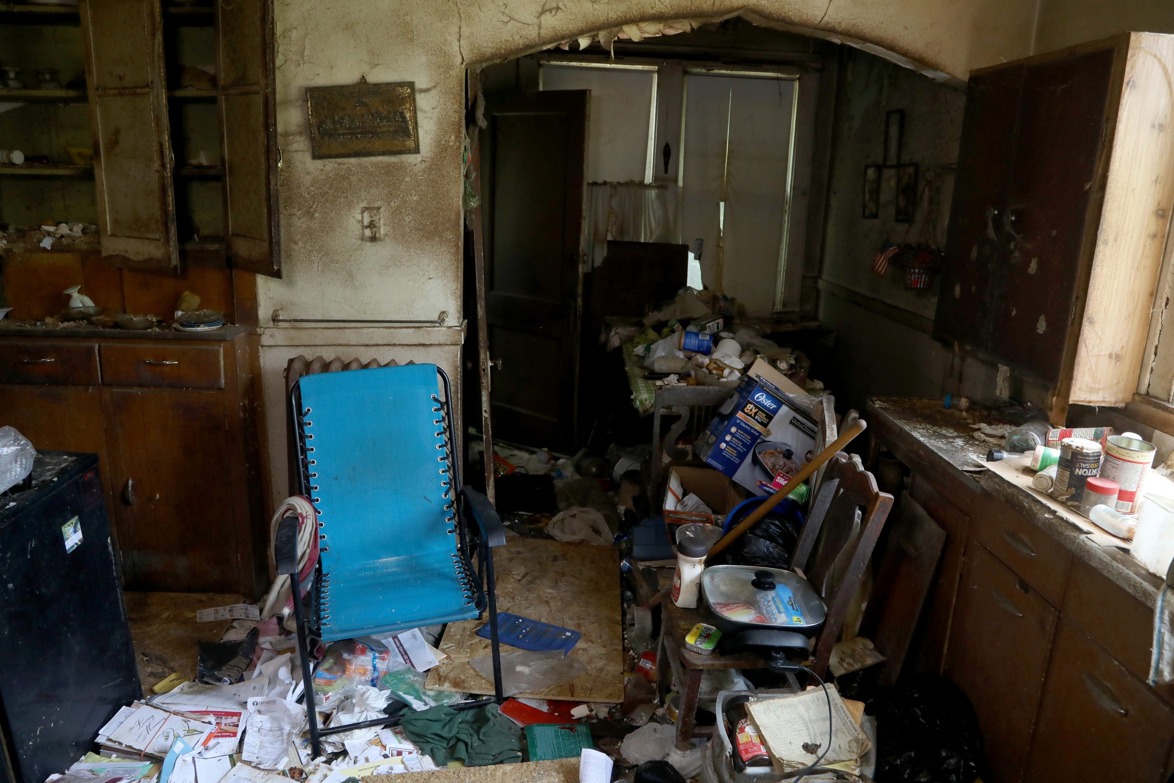 In the kitchen, the blue lawn chair that Sally Honeycheck used as a bed is also where she was found dead in late November of 2018. Sally and her sister Lorraine Honeycheck shared this home for decades and lived in filth and squalor.