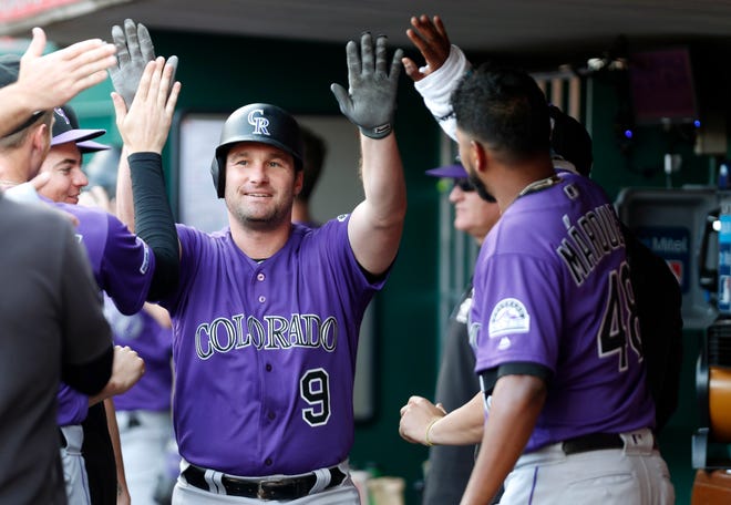 First baseman Daniel Murphy celebrates with teammates after hitting a three-run homer Friday night at Cincinnati. The Rockies return home from a 10-game road trip Monday for a 6:40 p.m. game against the Los Angeles Dodgers at Coors Field in Denver.