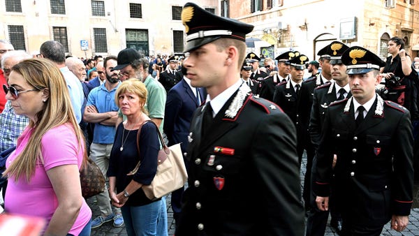 People and Carabinieri arrive to pay their...