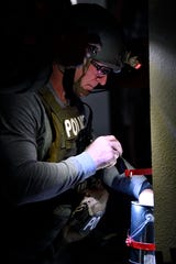 George Ewing of the Austin Police Department works on a simulated bomb on Dyess Air Force Base.