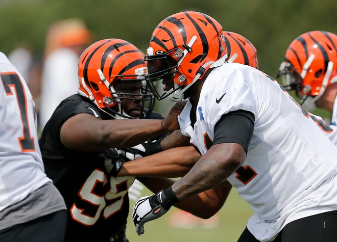 Cincinnati Bengals defensive tackle Andrew Billings (99) and offensive tackle John Jerry (64) face off on a play during practice on day three of training camp at the Paul Brown Stadium practice field in downtown Cincinnati on Monday, July 29, 2019.