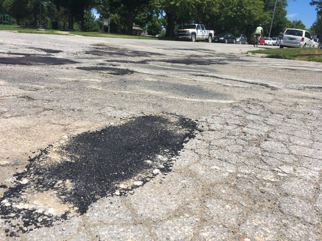Iowa City will be filling potholes and sweeping E. College St.