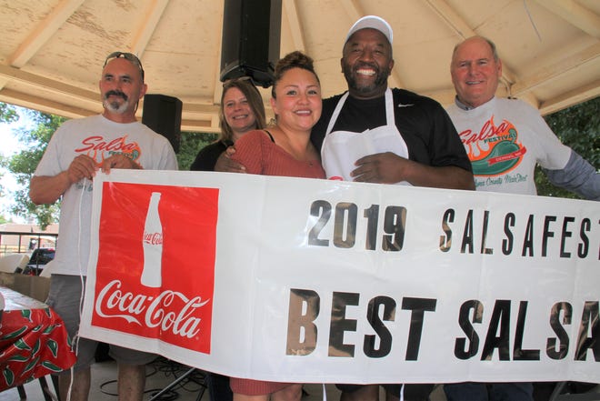 Torre Johnson and wife Bella show off their 2019 Salsa fest banner.