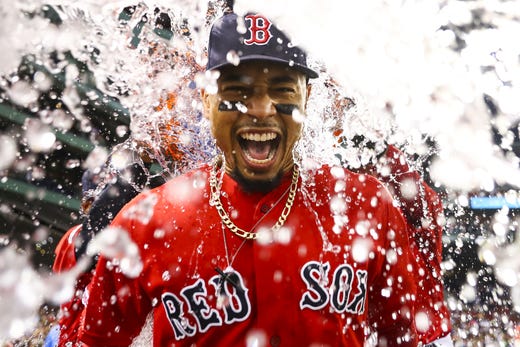 Mookie Betts of the Boston Red Sox is showered in Gatorade after the Boston Red Sox defeated the New York Yankees 10-5 at Fenway Park on July 26, 2019 in Boston.
