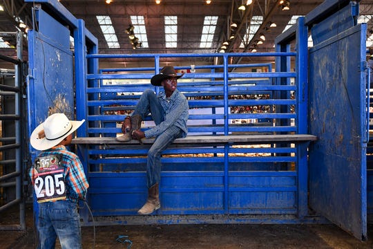 Kid competitors relax backstage before the 35th annual Bill Pickett Rodeo, July 20, 2019. 