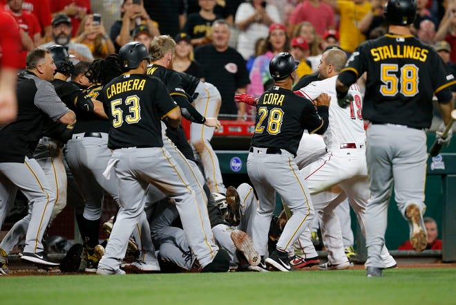 The Cincinnati Reds and Pittsburgh Pirates brawl in the ninth inning of the MLB National League game between the Cincinnati Reds and the Pittsburgh Pirates at Great American Ball Park in downtown Cincinnati on Tuesday, July 30, 2019. The Pirates won 11-4.