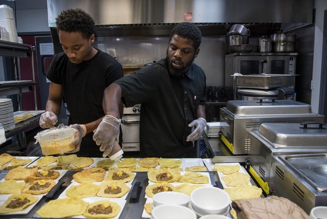 Kitchen chef Jaquan Mays and Angelo Knight prepare the second course during the Detroit Free Press/ Metro Detroit Chevy Dealers Top 10 Takeover of Norma G's in Detroit, Tuesday, July 30, 2019.