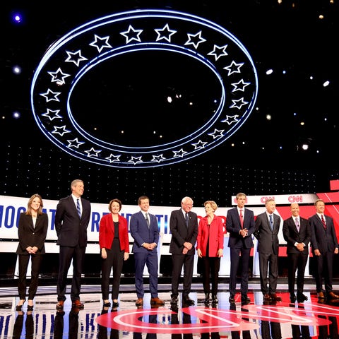 Democratic presidential candidates line up waving...