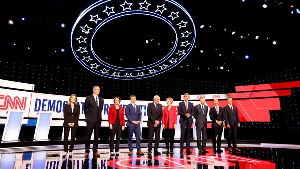 Democratic presidential candidates line up waving...