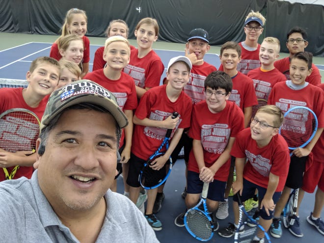 Bernie Fernandez takes a selfie with many of the junior players he has photographed during the 86th News Journal/Richland Bank Tennis Tournament at Lakewood Racquet Club