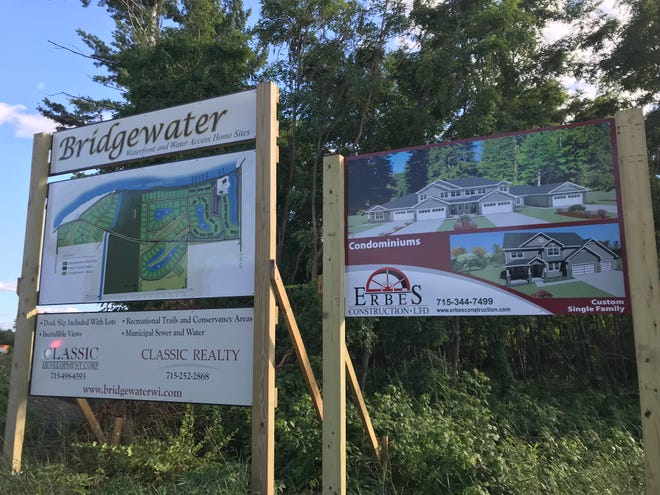 Signs show future plans for the Bridgewater project near Anchor Bay Bar & Grill in Biron.