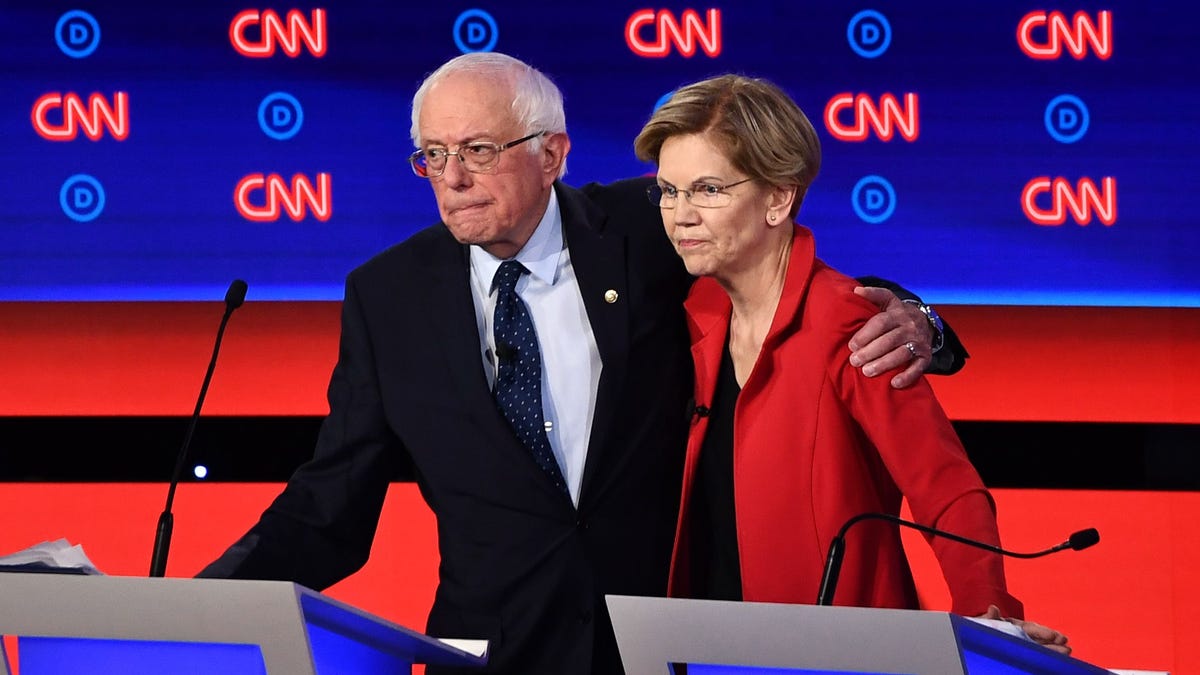 Democratic presidential hopefuls US senator from Vermont Bernie Sanders (L) and US Senator from Massachusetts Elizabeth Warren hug after participating in the first round of the second Democratic primary debate of the 2020 presidential campaign season hosted by CNN at the Fox Theatre in Detroit, Michigan on July 30, 2019. (Photo by Brendan Smialowski / AFP)BRENDAN SMIALOWSKI/AFP/Getty Images