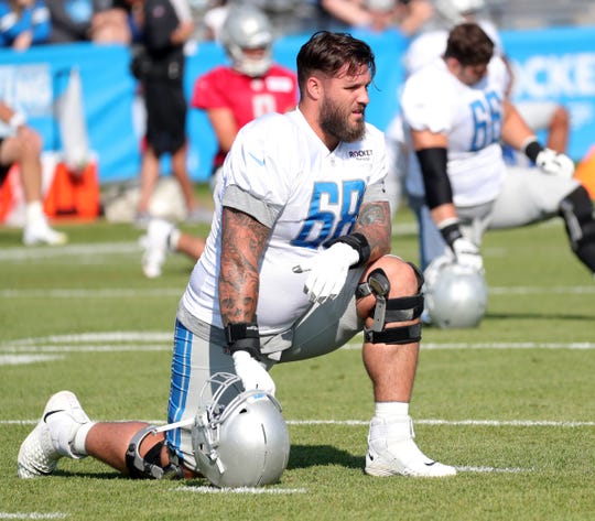 Lions offensive lineman Taylor Decker stretches during practice during training camp on Thursday, August 1, 2019, in Allen Park.