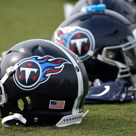 Titans helmets rest on the field during practice a
