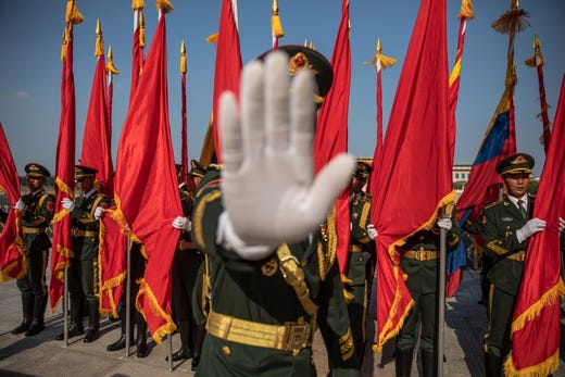 A member of an honor guard gestures to the photographer to stop taking photos prior to a welcome ceremony for Colombian President Ivan Duque Marquez at the Great Hall of the People in Beijing, China, July 31, 2019.