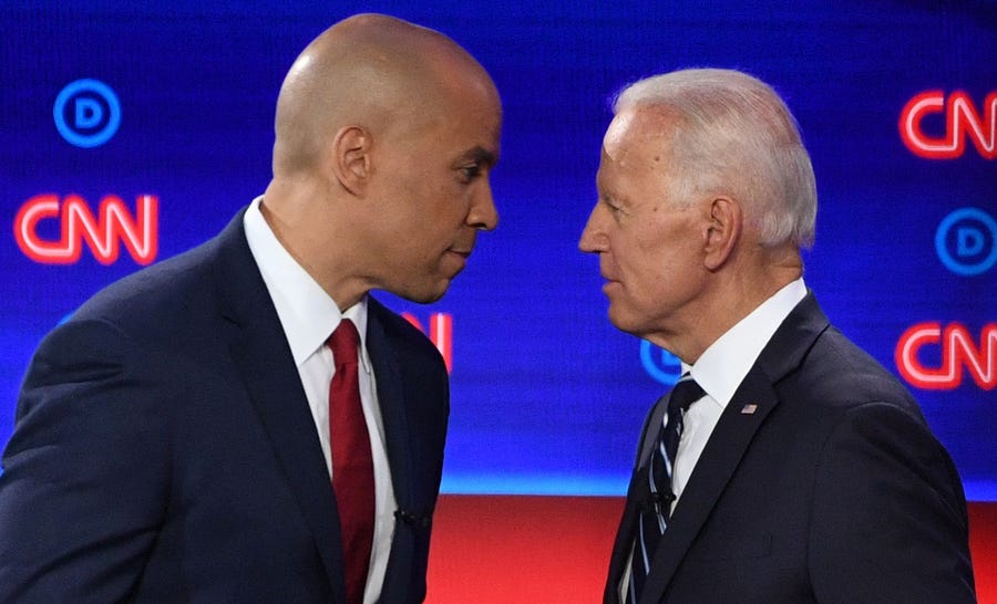 Democratic presidential hopefuls former Vice President Joe Biden and Sen. Cory Booker of New Jersey chat during a break in the second round of the second Democratic primary debate of the 2020 presidential campaign season hosted by CNN at the Fox Theatre in Detroit, Michigan on July 31, 2019.