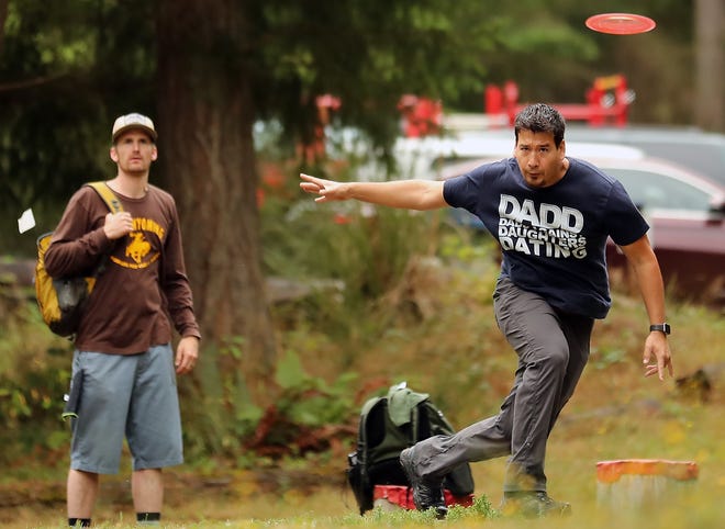 Jason Yeh lets his disc fly from the tee box of the second hole while taking part in the Deaf Disc Golf Association National Championships at the Bud Pell at Ross Farm Disc Golf Course in this file photo from August 2019. The course saw its last disc golfers over the weekend, as it will close to make way for a residential development.