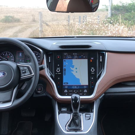 Subaru's DriverFocus uses an infrared camera hidden behind the dark space  above the navigation display.