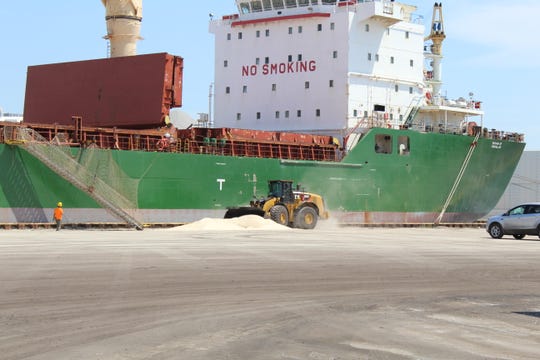 A front-end loader picks up road salt from a shipment that arrived from Egypt Friday at Fox River Terminals in Green Bay