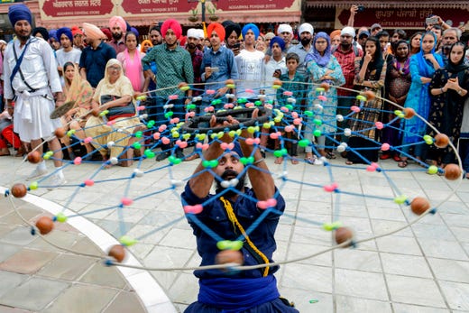 A Sikh devotee demonstrates his 'Gatka' traditional martial art skills during the 'Nagar Kirtan' procession to mark the 550th birth anniversary of Guru Nanak Dev, the founder of Sikhism, at the Golden Temple in Amritsar on August 2, 2019.