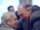 Interim MSU president John Engler, right, has a private conversation with his good friend, Oakland County Executive L. Brooks Patterson, before the interim president speaks.