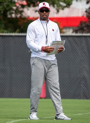 Running backs coach, Norval McKenzie runs drills at Louisville football's first practice of the season, Sunday, Aug. 4, 2019 in Louisville Ky.