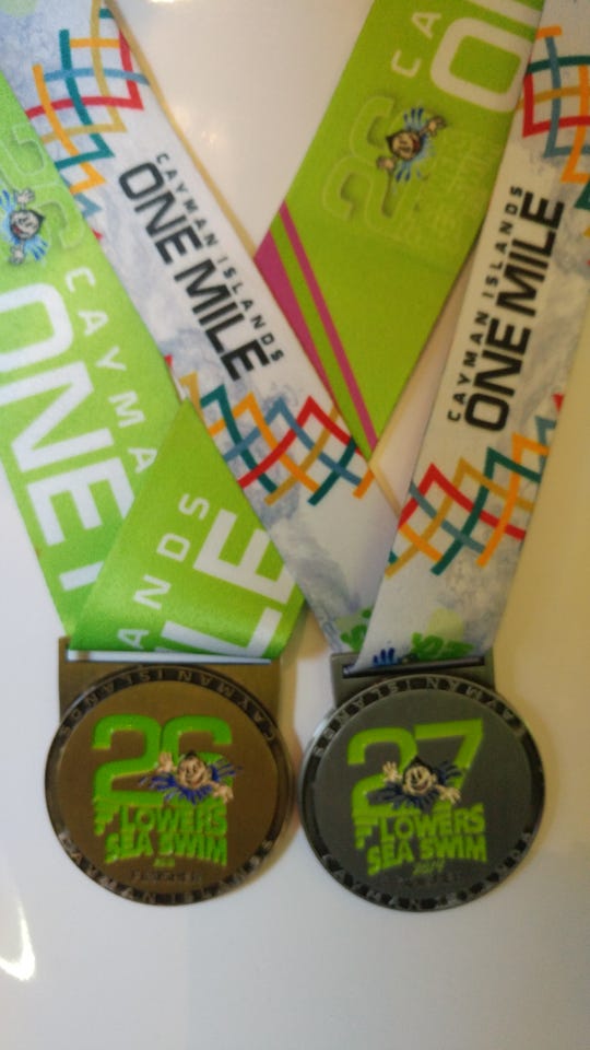 Allan Ripple's medals from completing two Flowers Sea Swim races. The one-mile swim raises money for cancer research.