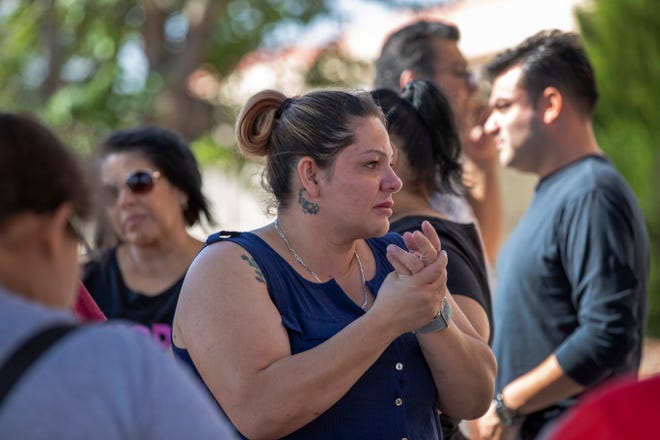 Relatives of victims of the Walmart mass shooting wait for information from authorities at the reunification center in El Paso, Texas, Sunday, Aug. 4, 2019. (AP Photo/Andres Leighton)