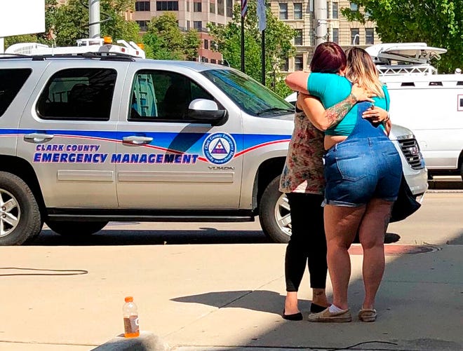 Residents comfort each other as they await word on whether they know any of the victims of a mass shooting on Sunday, Aug. 4, 2019, in Dayton, Ohio. (AP Photo/Julie Carr Smyth)