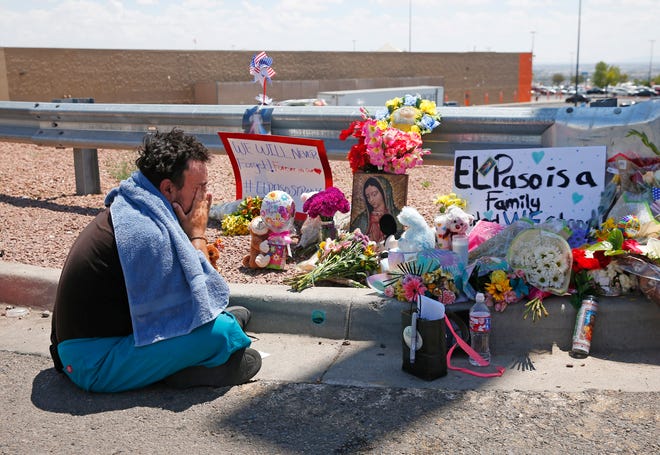 Felipe Avila mourns outside Walmart in El Paso on Aug. 4, 2019.