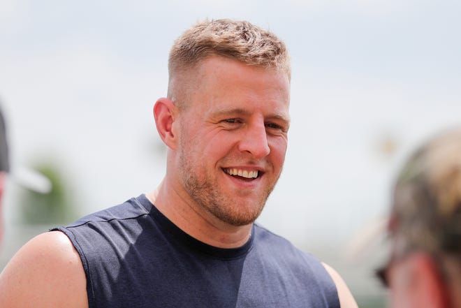 Texans defensive end J. J. Watt talks to fans after a joint training camp practice with the Green Bay Packers Monday in Ashwaubenon.