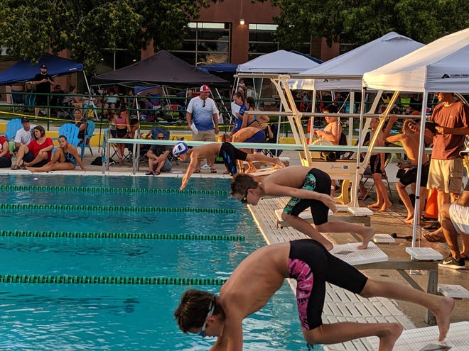 Youth swimmers take off from the blocks during a swim competition in Mesquite last week.