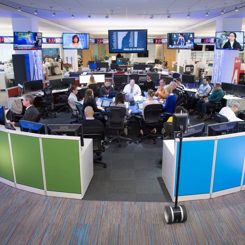 Staff gathers in the USA TODAY newsroom during a m