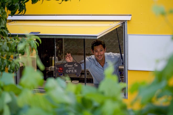 Ryan Goldhammer, co-owner of Pignic Pub & Patio, takes a moment in the Pig Shack Eatery kitchen trailer. The trailer anchors the new Pig Shack Eatery restaurant at Pignic on Flint Street in Reno.