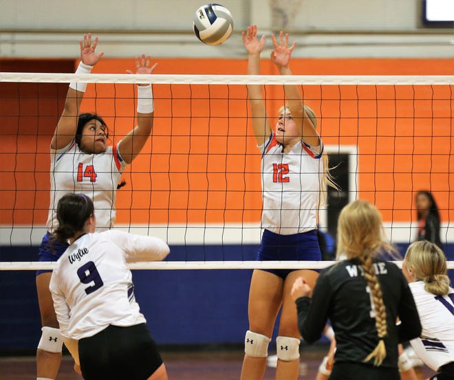 San Angelo Central High School's Veronica Guerrero (14) and Presley Knowlton try to block a shot by Abilene Wylie's Keetyn Davis during the season-opening volleyball match at Central's Trevino gym on Tuesday, Aug. 6, 2019. Wylie won in four sets.