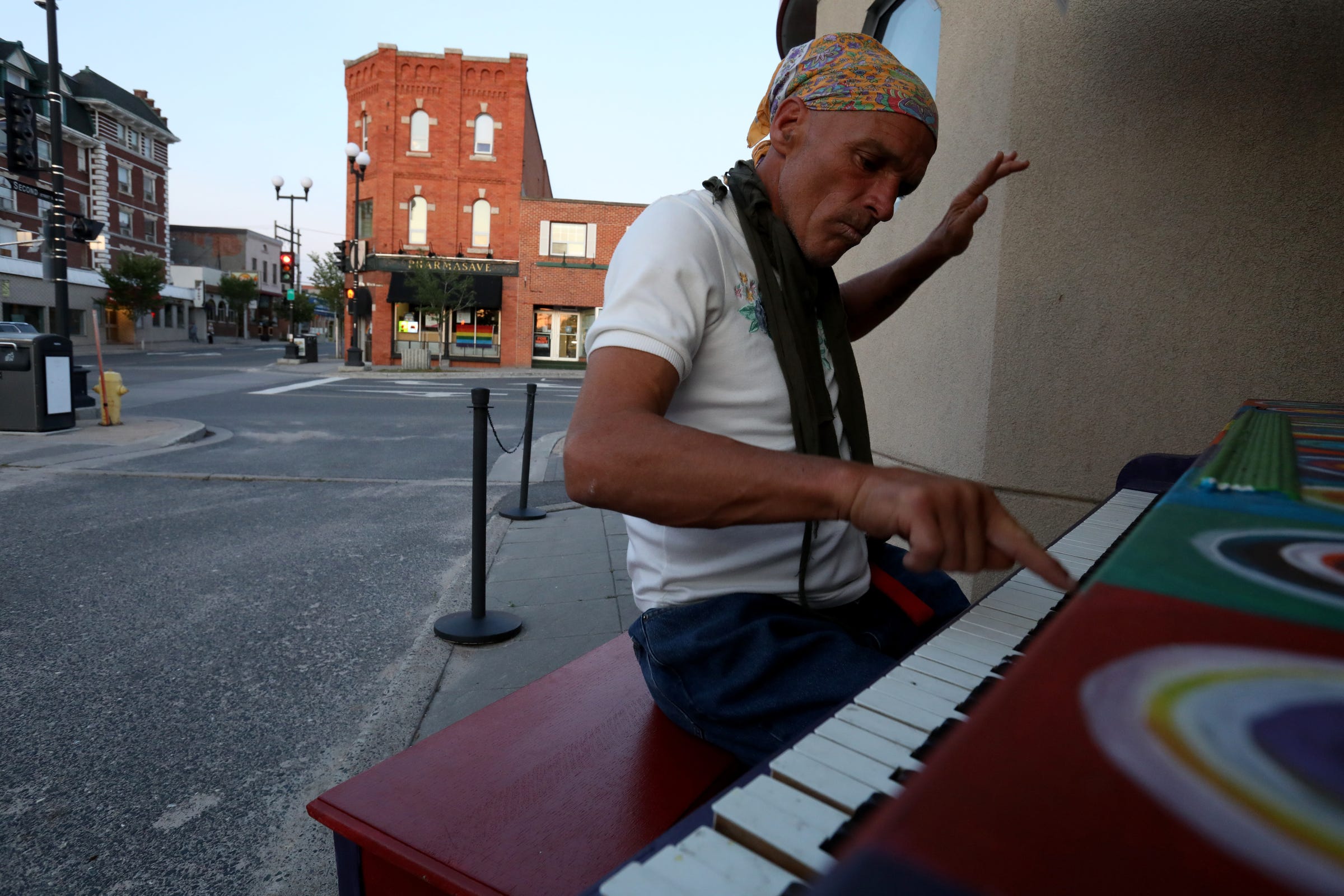 Out and about at dusk on Wednesday, July 10, 2019 in Kenora, Ontario, Canada, Joe Murphy plays piano at one of the few piano art installations around the town.
After living in a hotel in Kenora, Ontario, Canada set up by former NHL hockey players, former Detroit Red Wings player Joe Murphy is back on the streets of that city and homeless. 
Murphy still wanders the town sleeping out in the open in different places, getting food and clothing from the Fellowship Centre that helps the homeless population in Kenora.

