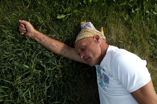 Joe Murphy sleeps underneath the Canadian Tire gas station sign that many residents of Kenora, Ontario, Canada are use to seeing him at.
Often people stop by bringing him food from McDonalds to Tim Horton's like this man did for him on Wednesday, July 10, 2019 
After living in a hotel in Kenora, Ontario, Canada set up by former NHL hockey players, former Detroit Red Wings player Joe Murphy is back on the streets of that city and homeless. 



