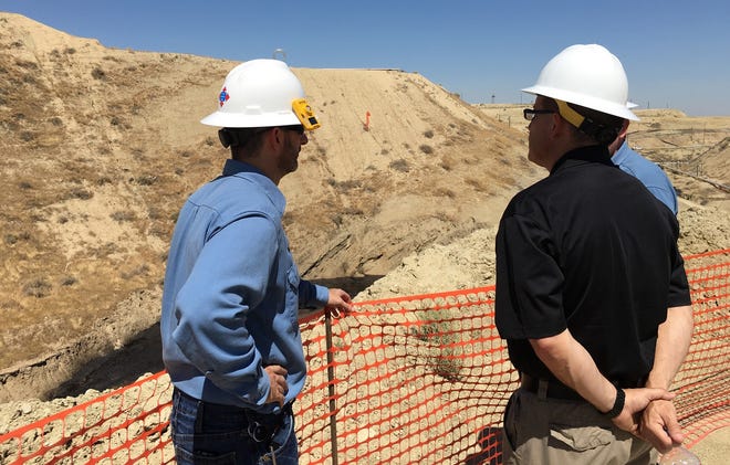 California's acting oil and gas supervisor, Jason Marshall, in black shirt, and Chevron staff at site of massive Cymric 1Y blowout. July 2019