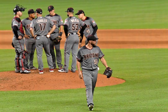 Jul 29, 2019: Arizona Diamondbacks relief pitcher Greg Holland (56) is taken out of the game by Diamondbacks manager Torey Lovullo (17) during the seventh inning against the Miami Marlins at Marlins Park.