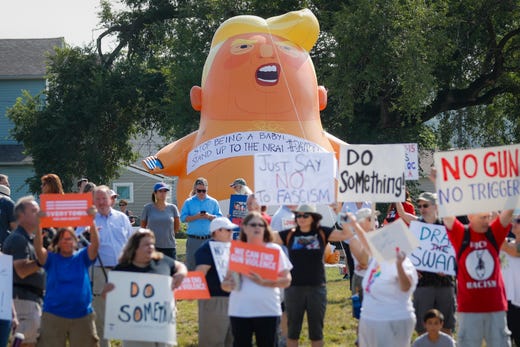 Demonstrators gather to protest the arrival of President Donald Trump outside Miami Valley Hospital after a mass shooting that occurred in the Oregon District early Sunday morning, Wednesday, Aug. 7, 2019, in Dayton. A gunman opened fire in Dayton early Sunday, killing several people including his sister, before officers fatally shot him.