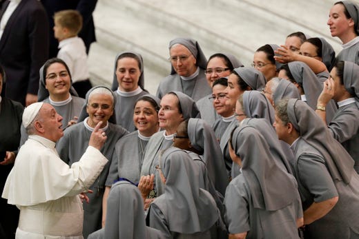 Pope Francis talks with a group of nuns during his weekly general audience, in the Pope Paul VI hall, at the Vatican on Aug. 7, 2019.
