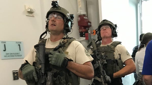 Police in tactical gear at the Gannett...