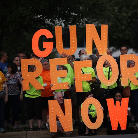 Advocates of gun reform legislation hold a candle 